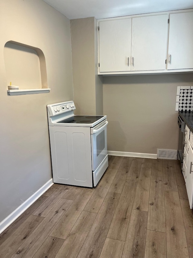 1017 Sibley Ave S, Litchfield, MN 55355 - laundry area featuring cabinet space and hardwood / wood-style floors