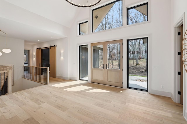 6176 Broadview Ave, Credit River Twp, MN 55372 - entrance foyer with a barn door, hardwood / wood-style floors, healthy amount of natural light, a towering ceiling, and recessed lighting
