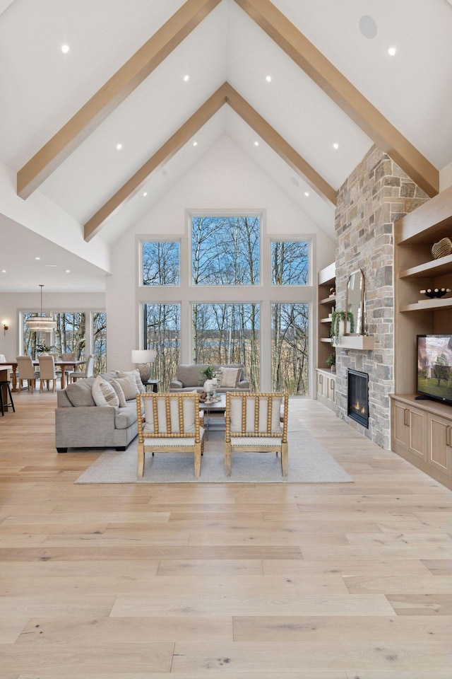 6176 Broadview Ave, Credit River Twp, MN 55372 - living room featuring high vaulted ceiling, beam ceiling, a stone fireplace, light wood finished floors, and recessed lighting