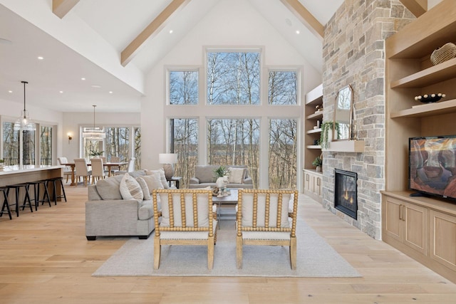 6176 Broadview Ave, Credit River Twp, MN 55372 - living area with high vaulted ceiling, a stone fireplace, recessed lighting, beam ceiling, and light wood-style flooring
