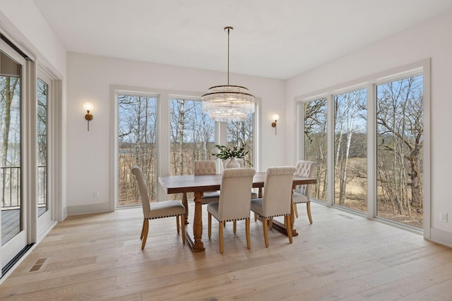 6176 Broadview Ave, Credit River Twp, MN 55372 - dining area with plenty of natural light, light wood-style flooring, and a chandelier