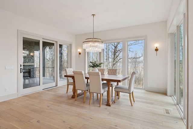 6176 Broadview Ave, Credit River Twp, MN 55372 - dining area with healthy amount of natural light, light wood-style floors, and a chandelier