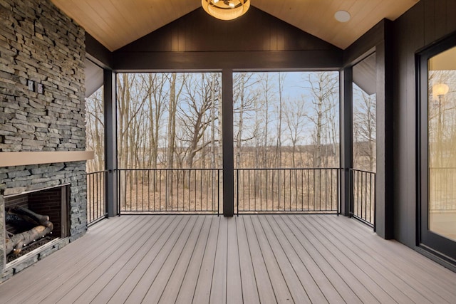 6176 Broadview Ave, Credit River Twp, MN 55372 - unfurnished sunroom featuring an outdoor stone fireplace and lofted ceiling