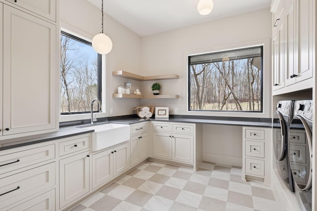 6176 Broadview Ave, Credit River Twp, MN 55372 - laundry area with independent washer and dryer, cabinet space, and light flooring