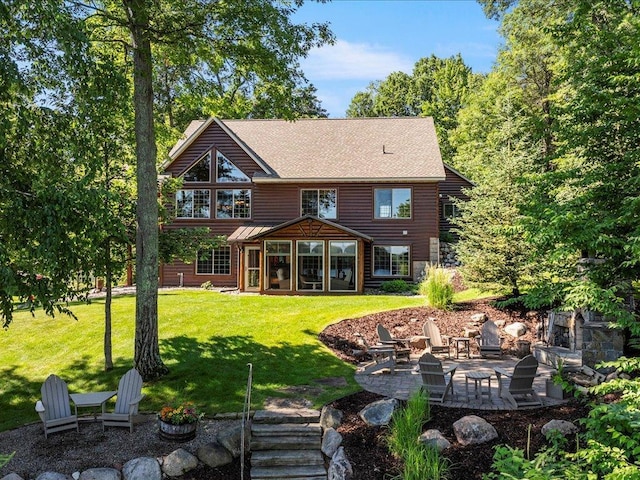 13598 Ox Cove Trl, Crosslake, MN 56442 - rear view of house with an outdoor fire pit, a patio, a sunroom, a lawn, and roof with shingles