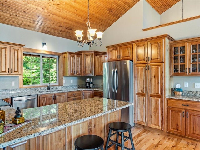 13598 Ox Cove Trl, Crosslake, MN 56442 - kitchen featuring wooden ceiling, stainless steel appliances, brown cabinetry, light stone counters, and high vaulted ceiling