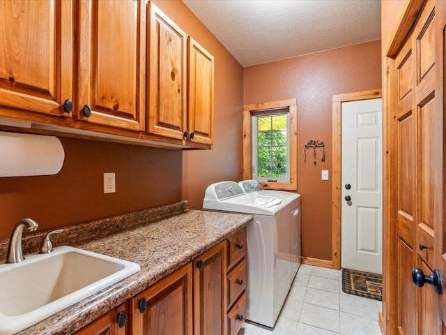 13598 Ox Cove Trl, Crosslake, MN 56442 - washroom with separate washer and dryer, cabinet space, light tile patterned floors, and a textured ceiling