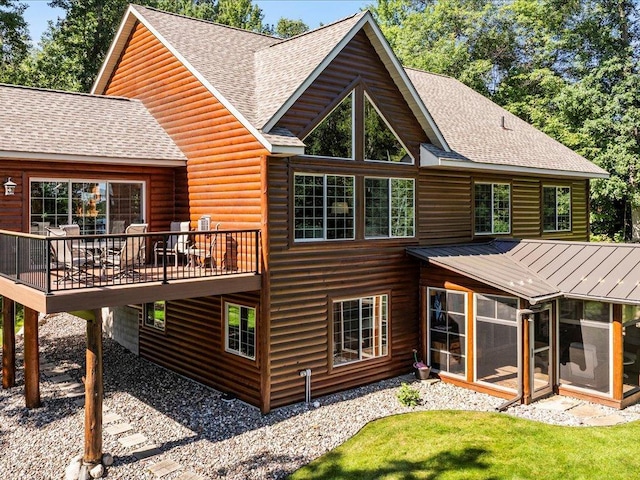 13598 Ox Cove Trl, Crosslake, MN 56442 - back of house featuring a sunroom, roof with shingles, a deck, log veneer siding, and a standing seam roof