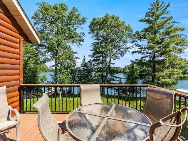 13598 Ox Cove Trl, Crosslake, MN 56442 - wooden deck featuring outdoor dining space, a water view, and a yard