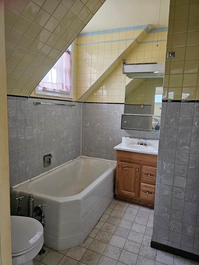 700 Hipple Ave, Henning, MN 56551 - bathroom featuring tile walls, a garden tub, vanity, and tile patterned flooring