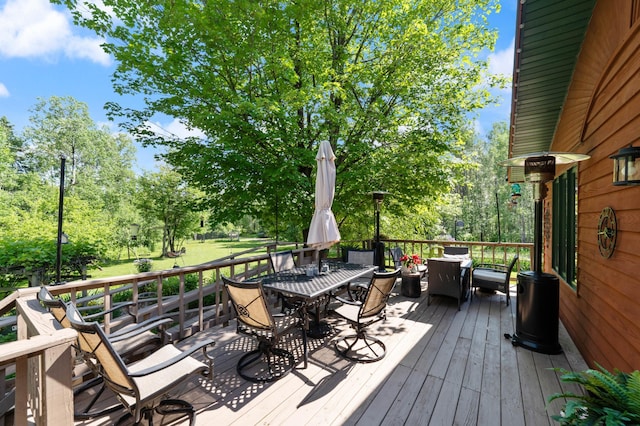 589 Seboe Rd, Wrenshall Twp, MN 55797 - deck with outdoor dining area and view of scattered trees