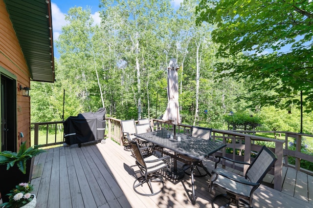 589 Seboe Rd, Wrenshall Twp, MN 55797 - deck with outdoor dining area, area for grilling, and view of scattered trees