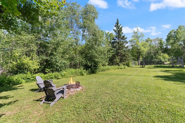 589 Seboe Rd, Wrenshall Twp, MN 55797 - view of grassy yard featuring an outdoor fire pit