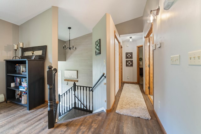 589 Seboe Rd, Wrenshall Twp, MN 55797 - corridor featuring an upstairs landing, wood finished floors, a chandelier, and vaulted ceiling