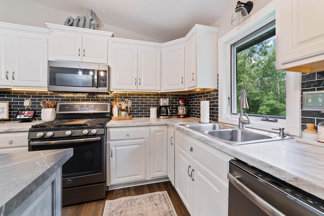 589 Seboe Rd, Wrenshall Twp, MN 55797 - kitchen featuring appliances with stainless steel finishes, vaulted ceiling, white cabinetry, a textured ceiling, and dark wood-style floors