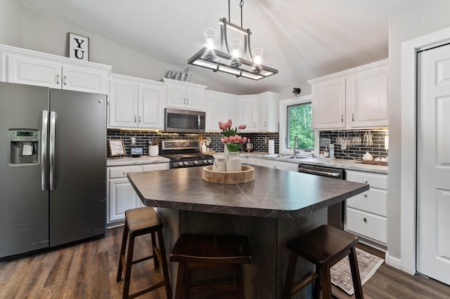 589 Seboe Rd, Wrenshall Twp, MN 55797 - kitchen with appliances with stainless steel finishes, white cabinets, lofted ceiling, and backsplash