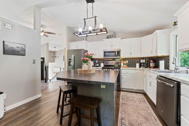 589 Seboe Rd, Wrenshall Twp, MN 55797 - kitchen with stainless steel appliances, lofted ceiling, backsplash, dark wood-style flooring, and ceiling fan