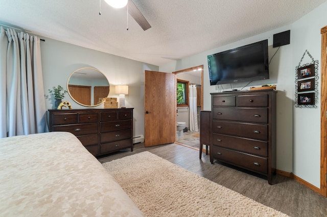 589 Seboe Rd, Wrenshall Twp, MN 55797 - bedroom with wood finished floors, a baseboard radiator, connected bathroom, a textured ceiling, and ceiling fan