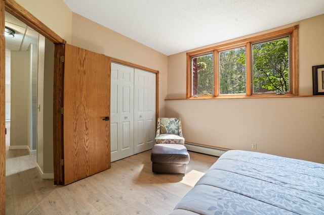 589 Seboe Rd, Wrenshall Twp, MN 55797 - bedroom with baseboard heating, light wood finished floors, and a closet