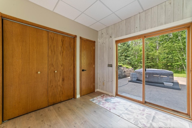 589 Seboe Rd, Wrenshall Twp, MN 55797 - doorway to outside with wooden walls, a paneled ceiling, and wood finished floors