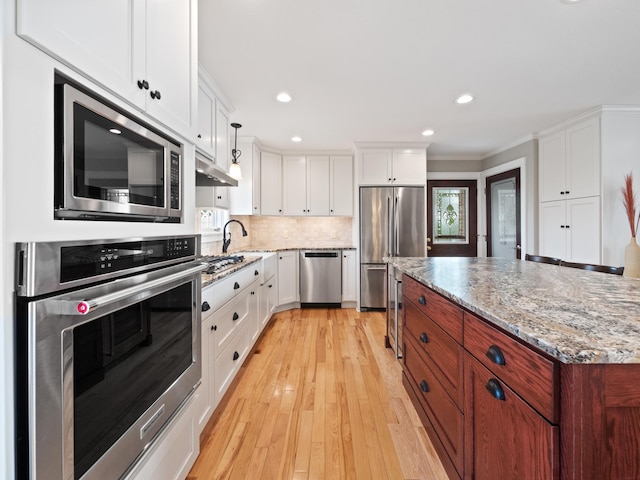 27842 Prairie Rose Rd, Elbow Lake, MN 56531 - kitchen with stainless steel appliances, white cabinetry, light wood-style flooring, light stone countertops, and recessed lighting
