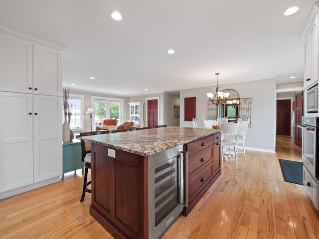 27842 Prairie Rose Rd, Elbow Lake, MN 56531 - kitchen featuring white oven, beverage cooler, light wood finished floors, white cabinetry, and recessed lighting