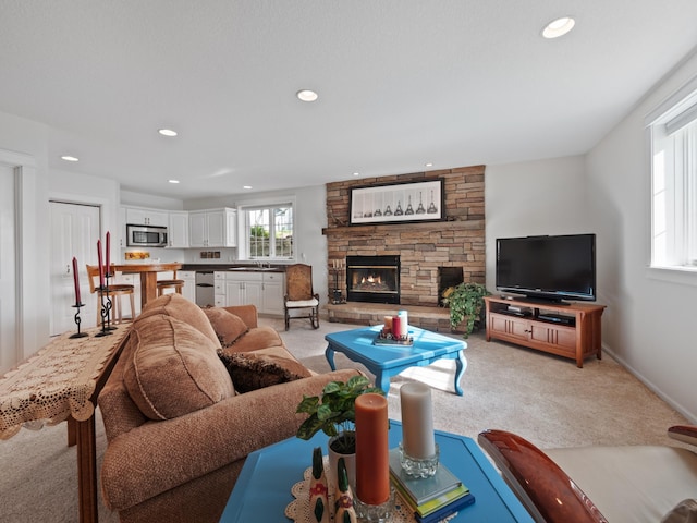 27842 Prairie Rose Rd, Elbow Lake, MN 56531 - living area featuring a stone fireplace, light colored carpet, and recessed lighting