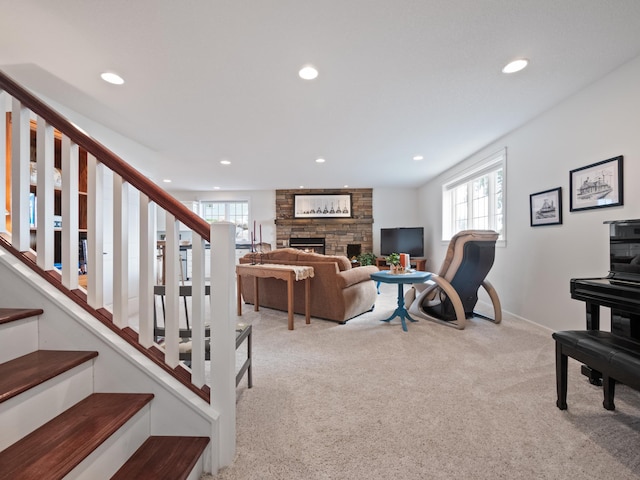 27842 Prairie Rose Rd, Elbow Lake, MN 56531 - carpeted living room featuring recessed lighting, plenty of natural light, a fireplace, and stairs