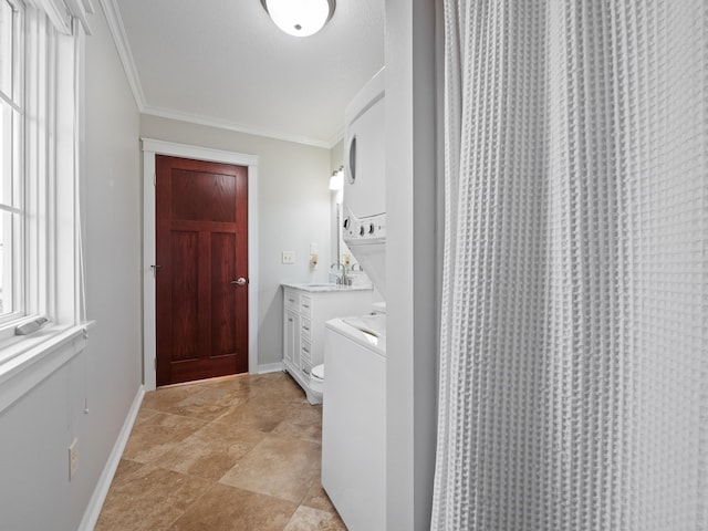 27842 Prairie Rose Rd, Elbow Lake, MN 56531 - laundry area with stacked washing machine and dryer, ornamental molding, and stone finish floors
