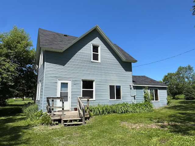 17864 County Road 66 NE, Eagle Bend, MN 56446 - rear view of property featuring a wooden deck, a yard, and roof with shingles