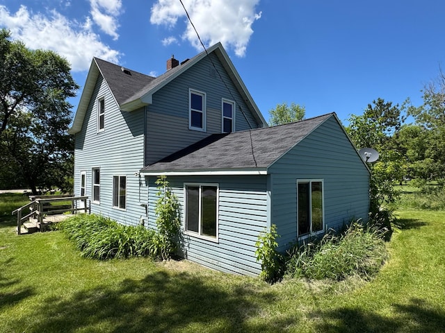 17864 County Road 66 NE, Eagle Bend, MN 56446 - rear view of property with a shingled roof, a yard, and a chimney