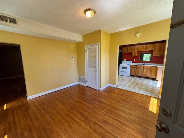 17864 County Road 66 NE, Eagle Bend, MN 56446 - unfurnished living room featuring light wood finished floors and a textured ceiling