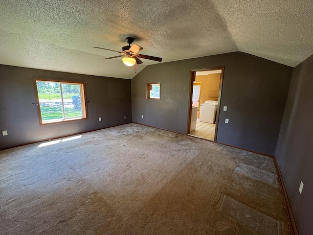 17864 County Road 66 NE, Eagle Bend, MN 56446 - carpeted spare room featuring vaulted ceiling, washer / clothes dryer, ceiling fan, and a textured ceiling