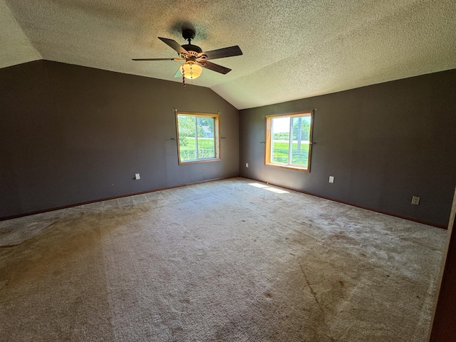 17864 County Road 66 NE, Eagle Bend, MN 56446 - unfurnished room with vaulted ceiling, ceiling fan, carpet flooring, and a textured ceiling