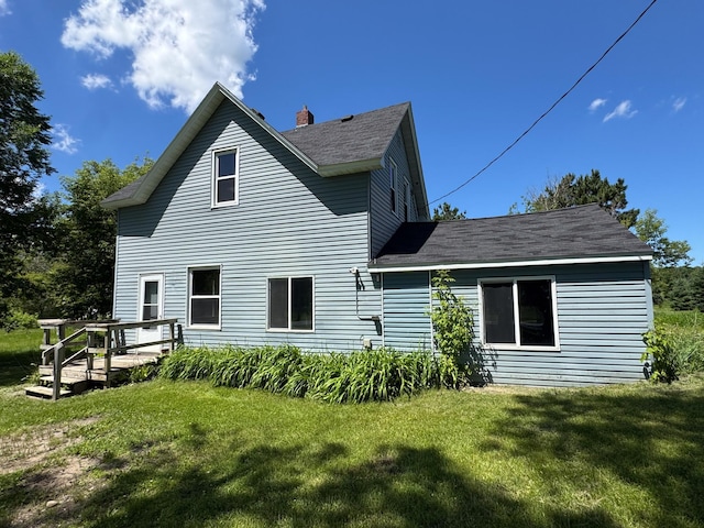 17864 County Road 66 NE, Eagle Bend, MN 56446 - rear view of house featuring a lawn, a wooden deck, and a shingled roof