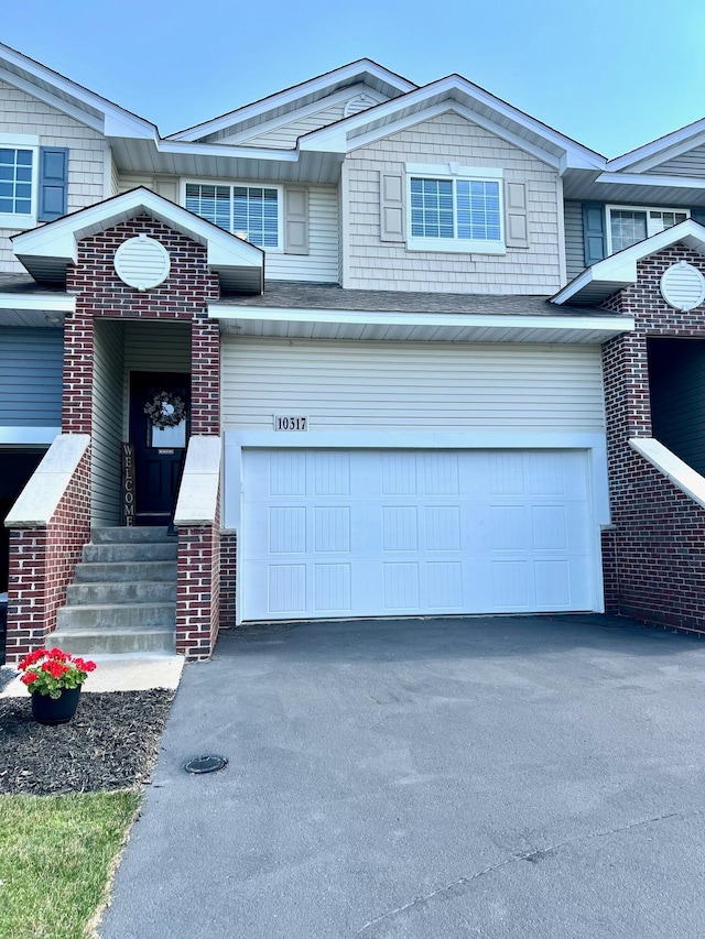10317 Kittredge Pkwy NE, Otsego, MN 55301 - view of property with asphalt driveway and an attached garage