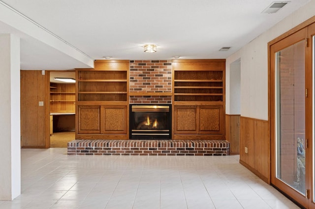 11 Eagle Ridge Rd, North Oaks, MN 55127 - unfurnished living room with built in shelves, wood walls, a fireplace, and wainscoting