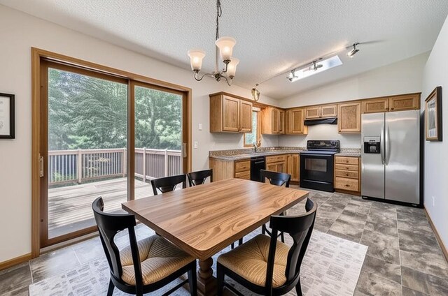 703 11th Ave SW, Isanti, MN 55040 - dining area featuring a textured ceiling, a chandelier, lofted ceiling, and rail lighting