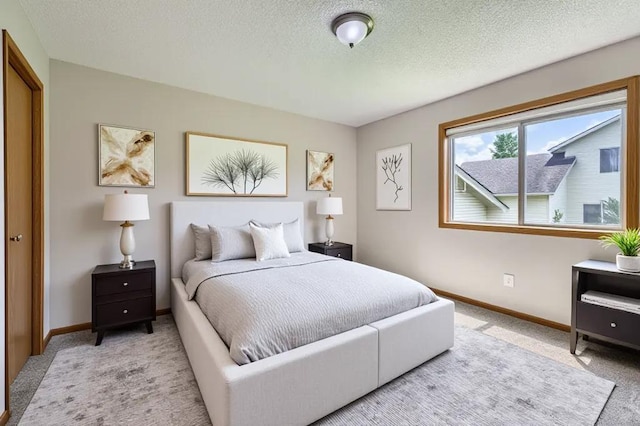 703 11th Ave SW, Isanti, MN 55040 - bedroom featuring light carpet and a textured ceiling
