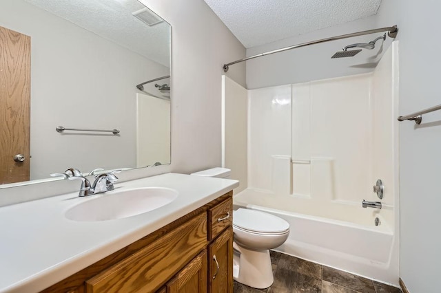 703 11th Ave SW, Isanti, MN 55040 - bathroom featuring a textured ceiling, vanity, and tub / shower combination