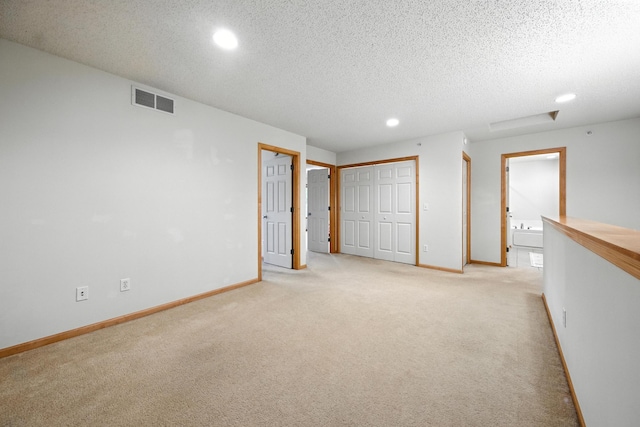 12240 Urbank St NE Unit G, Blaine, MN 55449 - unfurnished bedroom with light carpet, recessed lighting, and a textured ceiling