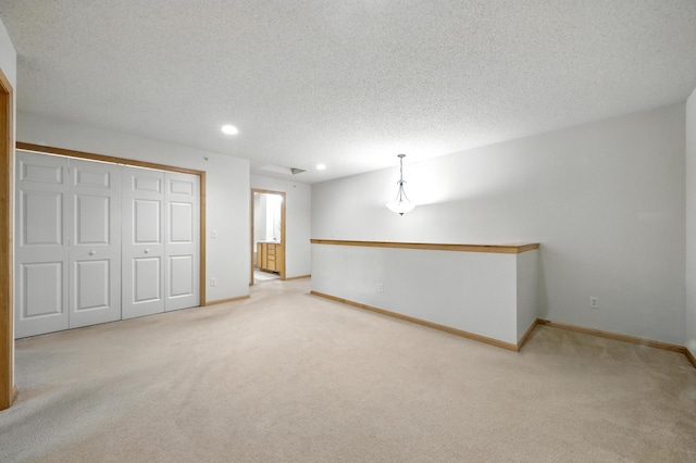 12240 Urbank St NE Unit G, Blaine, MN 55449 - below grade area featuring carpet floors, a textured ceiling, and recessed lighting