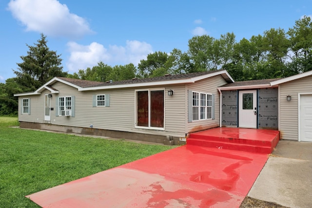 5070 10th St NW, Maple Lake, MN 55358 - rear view of house featuring a lawn, a shingled roof, and an attached garage