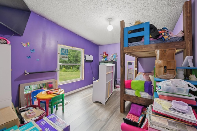 5070 10th St NW, Maple Lake, MN 55358 - bedroom featuring vaulted ceiling, a textured ceiling, and wood finished floors