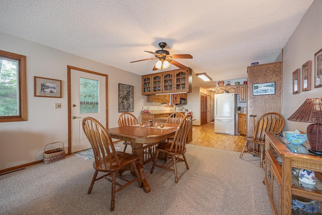 3925 Plainview Dr NW, Hackensack, MN 56452 - dining space with a textured ceiling, light colored carpet, and a ceiling fan