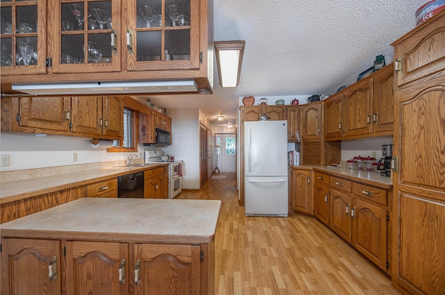3925 Plainview Dr NW, Hackensack, MN 56452 - kitchen with black appliances, brown cabinetry, light wood finished floors, glass insert cabinets, and light countertops