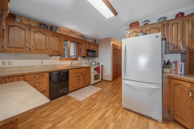 3925 Plainview Dr NW, Hackensack, MN 56452 - kitchen with black appliances, light wood-style floors, brown cabinets, and light countertops