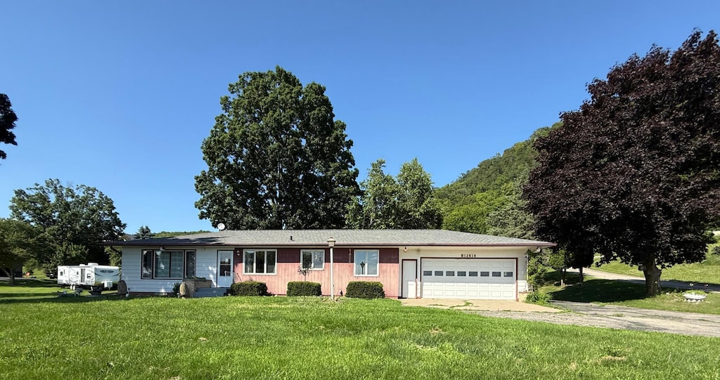 W12414 State Highway 35, Stockholm, WI 54769 - ranch-style home featuring concrete driveway, an attached garage, and a front lawn