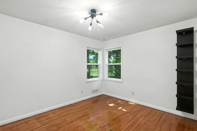2314 347th Ave NE, Cambridge Twp, MN 55008 - empty room with wood finished floors and a textured ceiling
