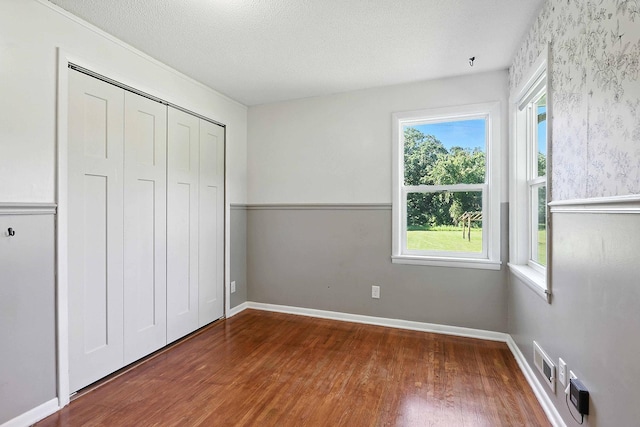 2314 347th Ave NE, Cambridge Twp, MN 55008 - unfurnished bedroom featuring wood finished floors, a closet, and a textured ceiling
